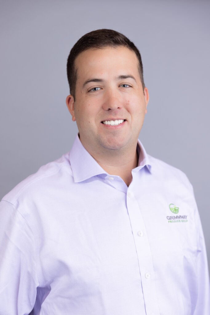 Professional headshot of man in lavender shirt