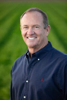 Smiling man in navy shirt outdoors